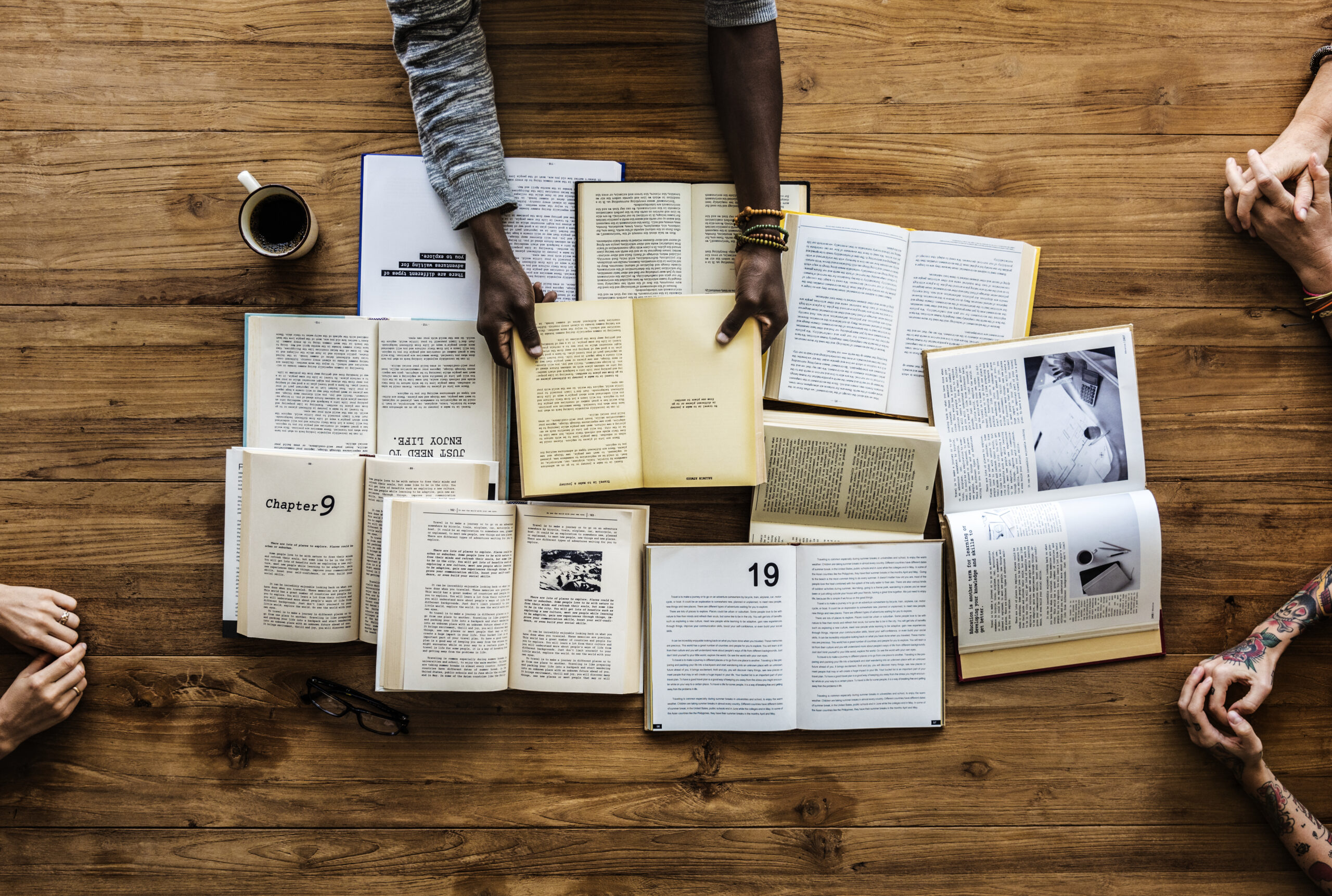 Open books spread across a wooden table